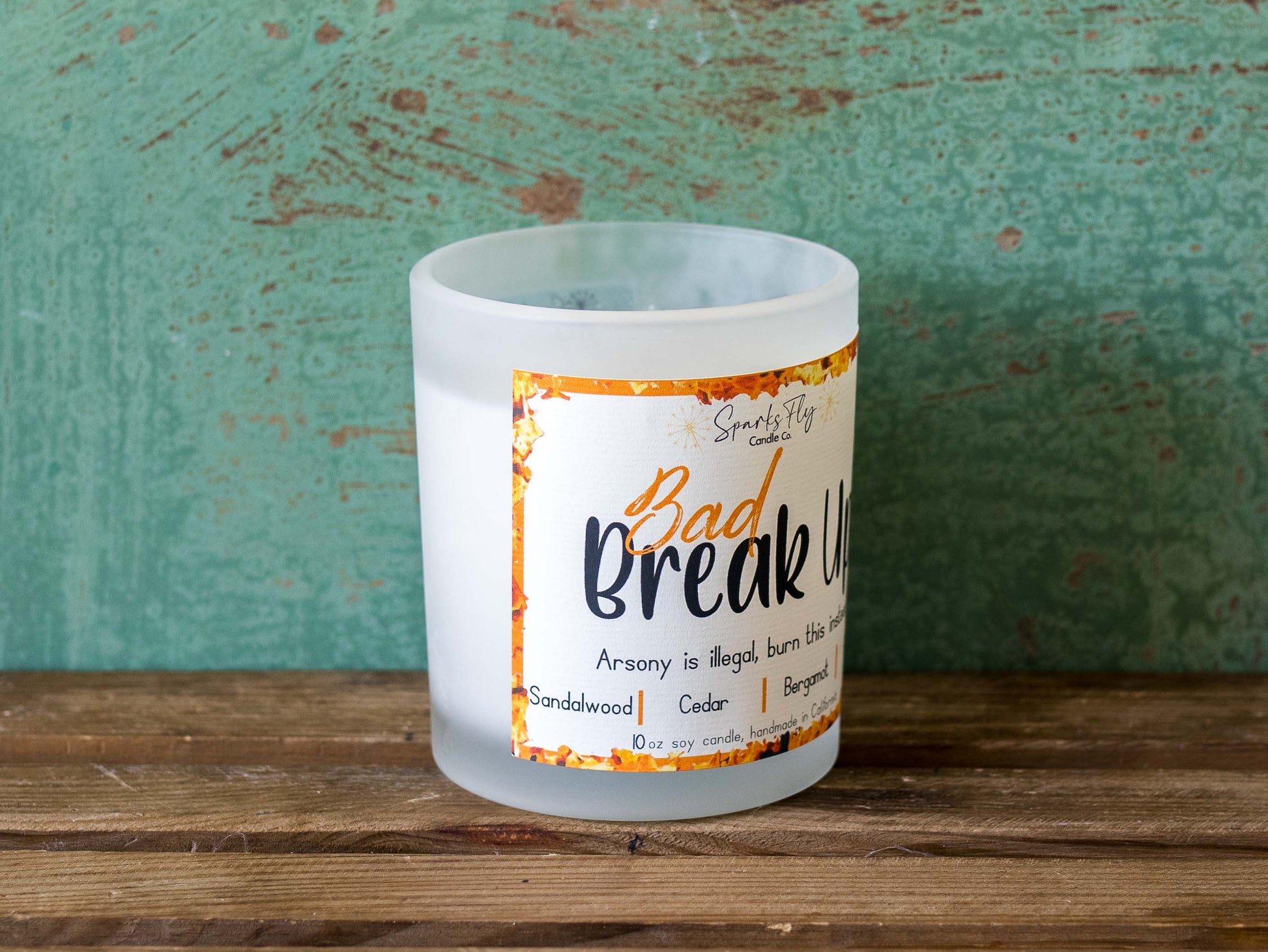 Bad Breakup sassy candle; promoting legal relief from heartbreak with a fiery scent twist, satire