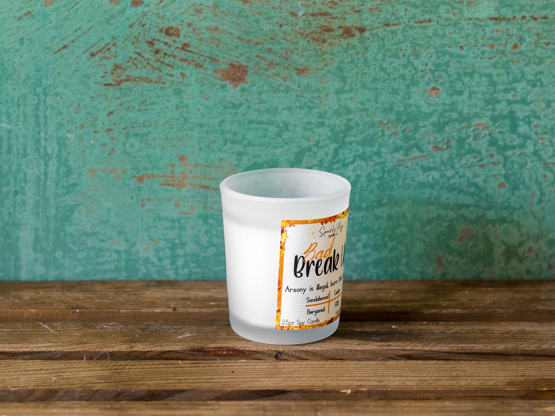 Bad Breakup sassy candle; promoting legal relief from heartbreak with a fiery scent twist, satire