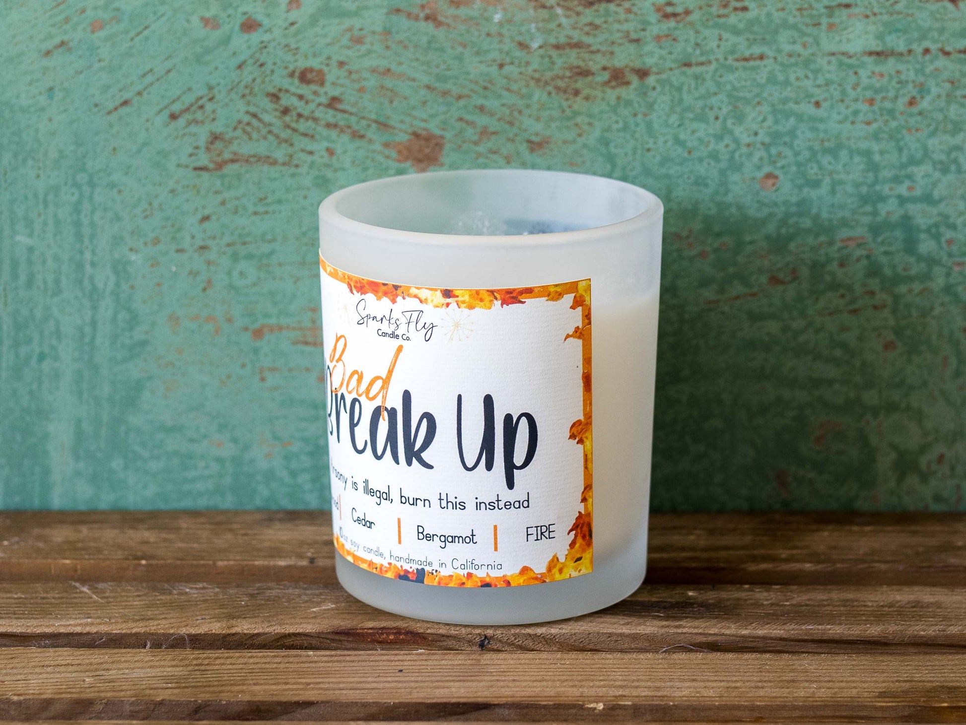 Bad Breakup sassy candle; promoting legal relief from heartbreak with a fiery scent twist, satire